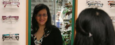 A woman trying on glasses in our West Auckland optometry practice